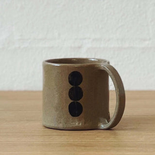 Taupe mug with black dot print